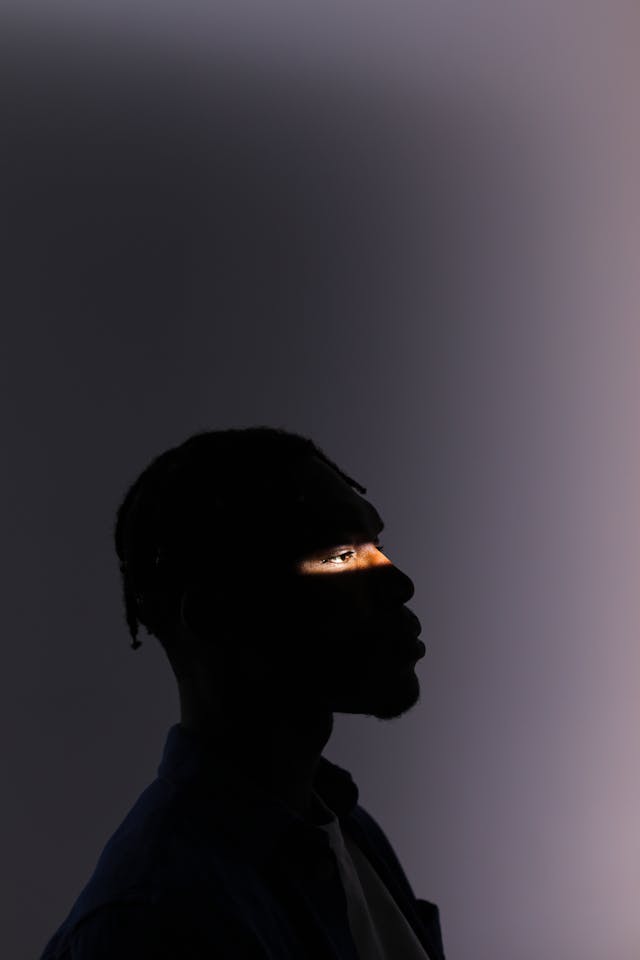 Sharpen Your Photographer’s Eye: Master the Art of Intentional Photography 1 photo of a man in shadow revealing his photographic eye, the photographer's eye, how to train your eye in photography